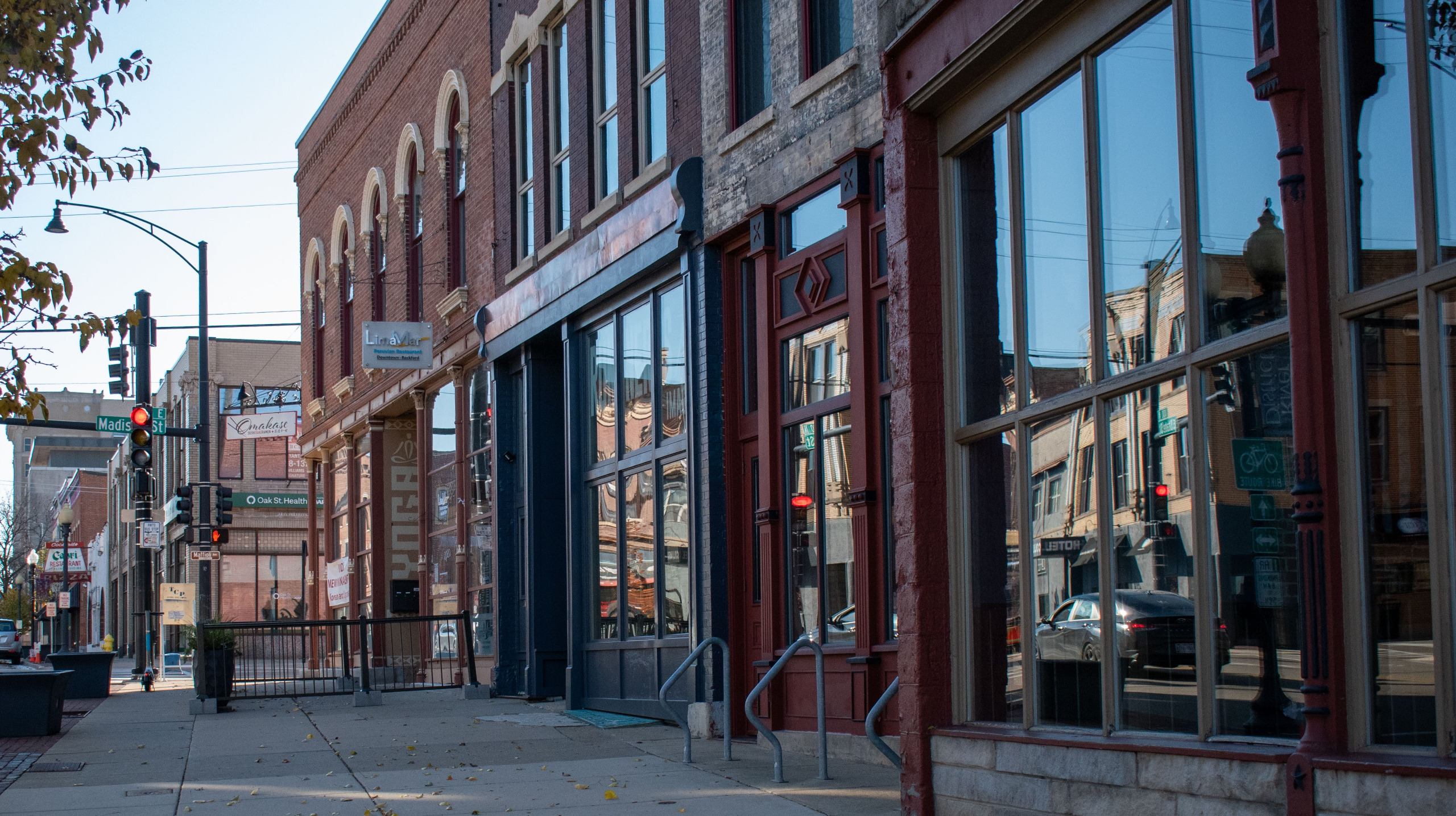 Image of urban sidewalk lined with brick historic storefronts