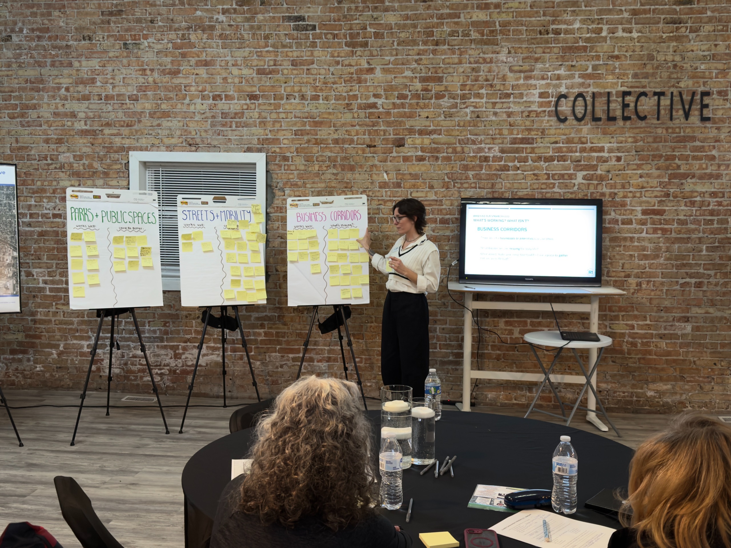 Image of R1 staff member describing a poster to community members at the MTP Open House Event in 2025.